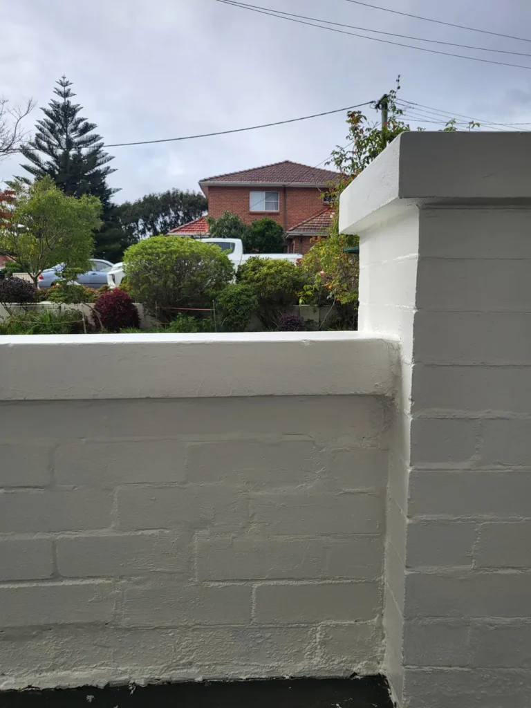 Brick wall fence after repair and painting