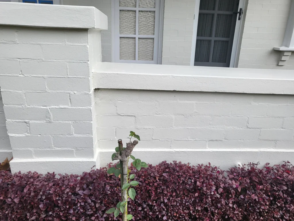 Brick wall after crack repair and paintwork