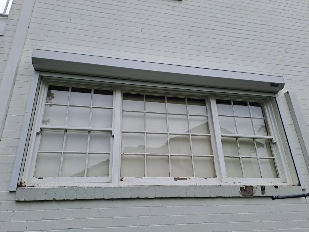 peeling and flaking colonial-style window