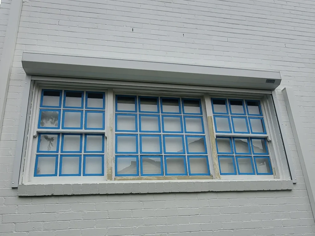 Double-hung colonial window prepped for painting