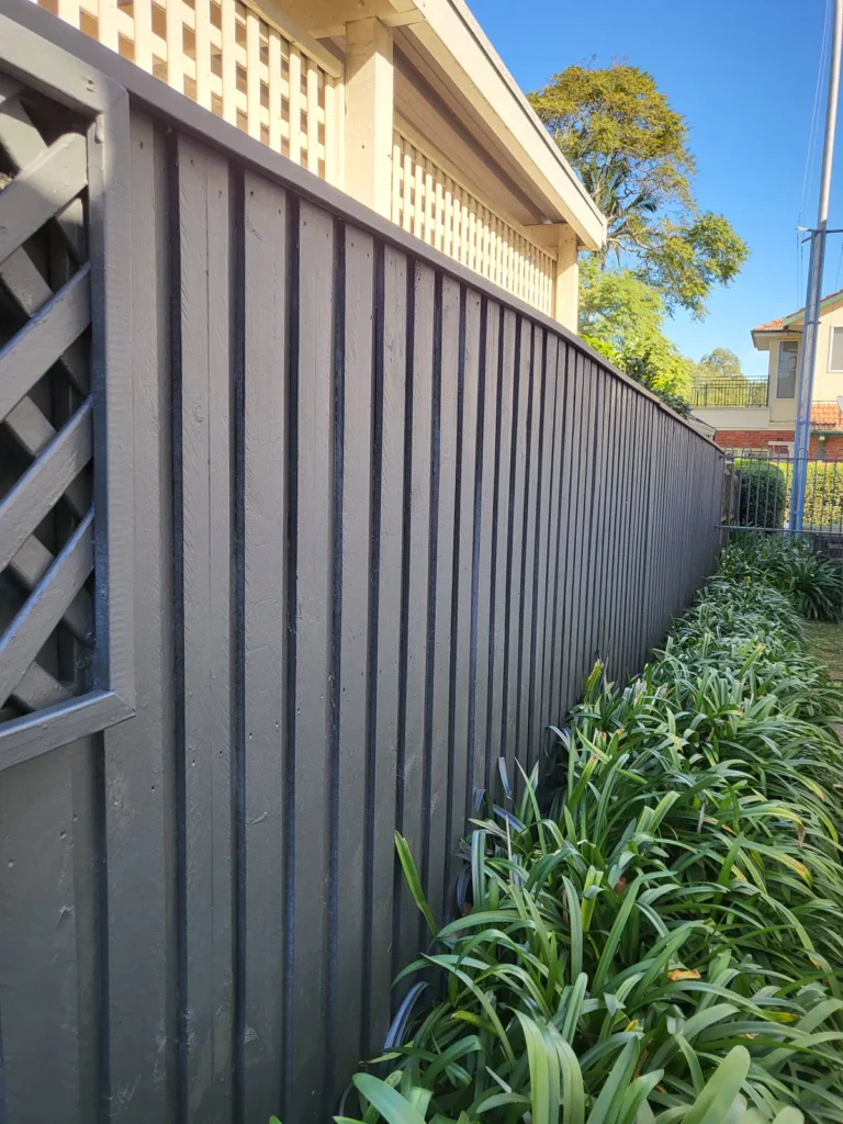 Side timber fence after painting