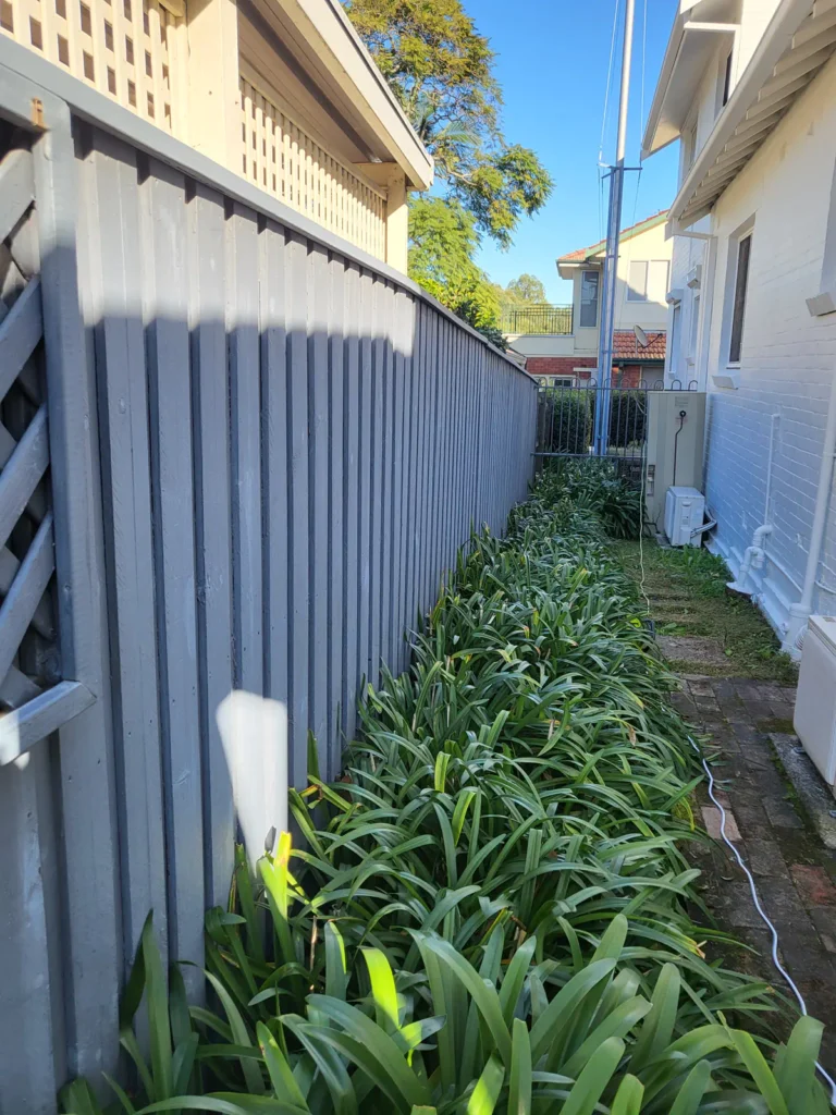 Side timber fence before painting
