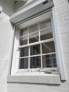 Sliding colonial grid window before painting in Sydney